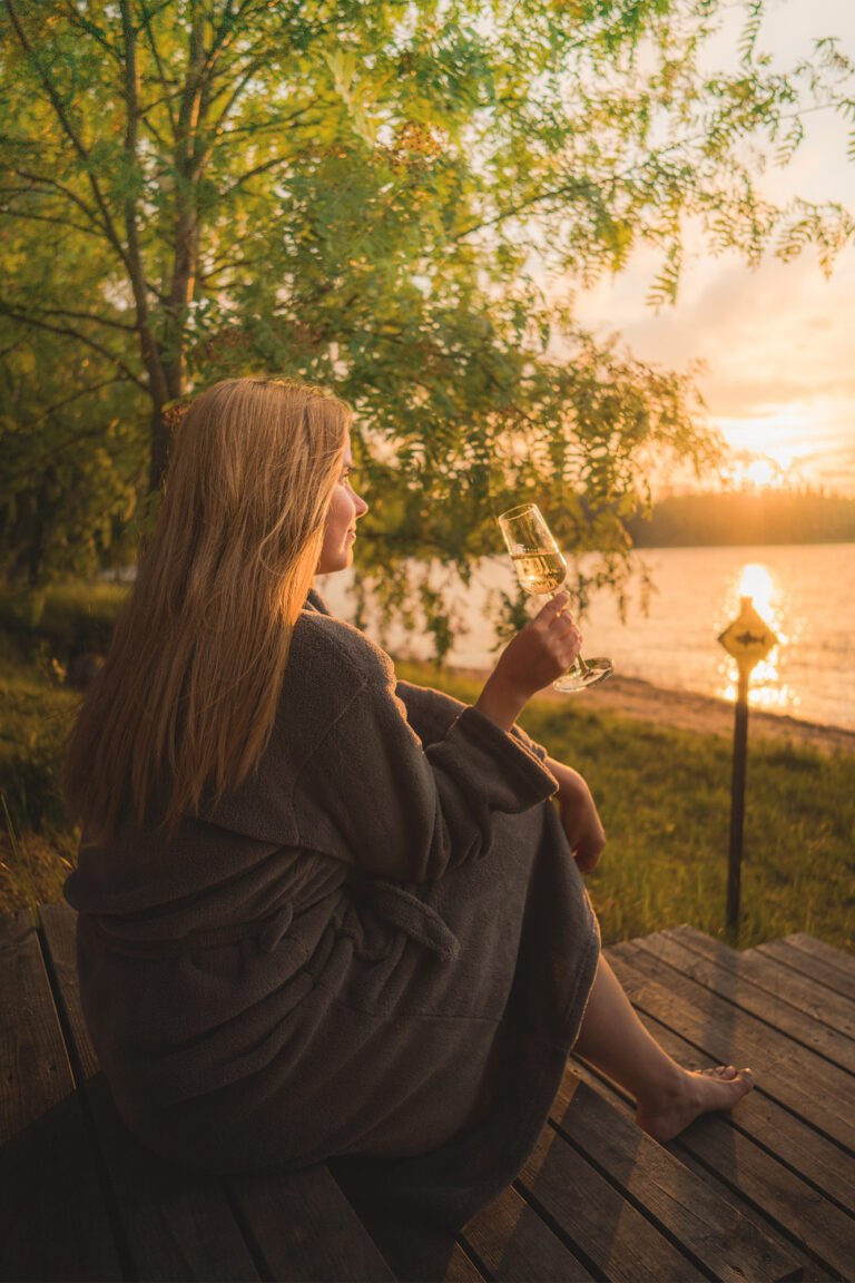 young woman looking at the serene landscape in Revontuli Resort