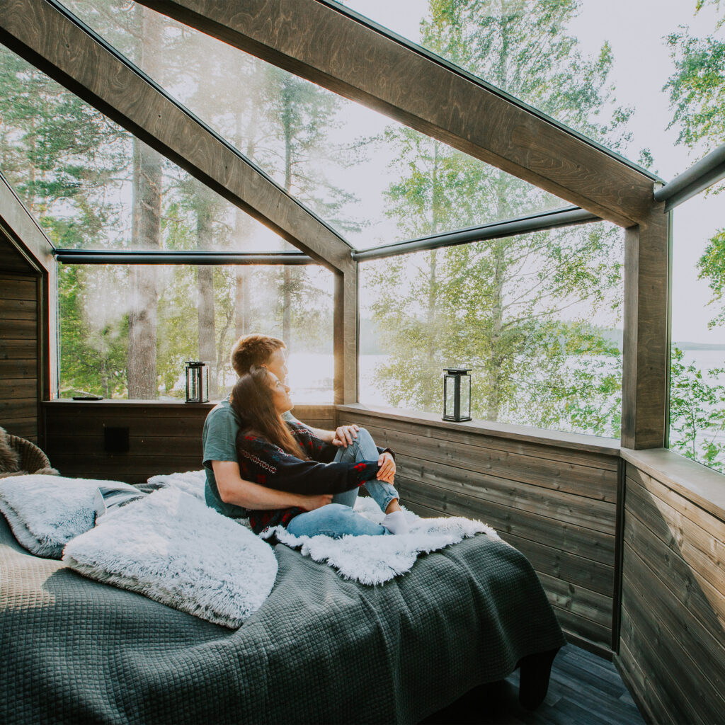 young couple relaxing in glass igloo