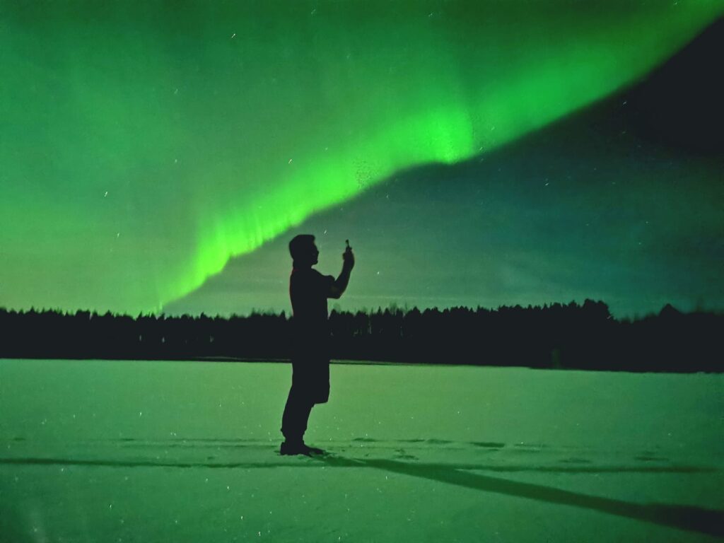 Man photographing the northern lights