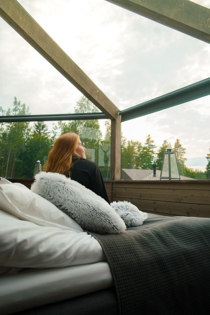 young woman relaxing at Sky Aurora Glass Igloo